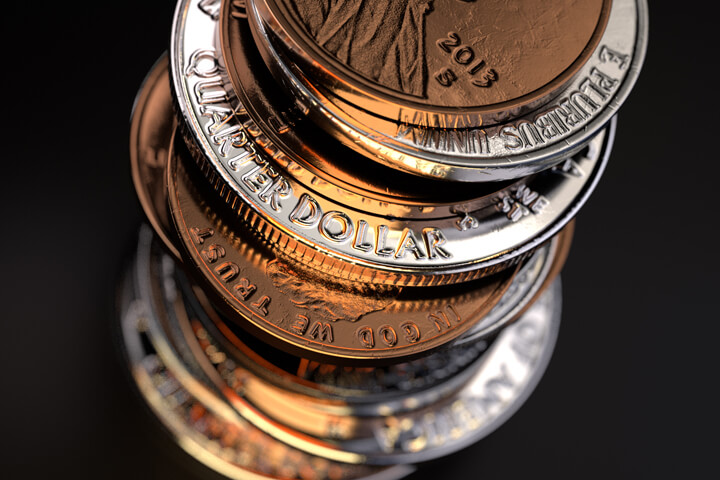 Closer top view of large stack of U.S. coins on black background
