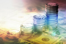 Increasing stacks of U.S. quarters on one hundred dollar bills with hard sun flare and overlay