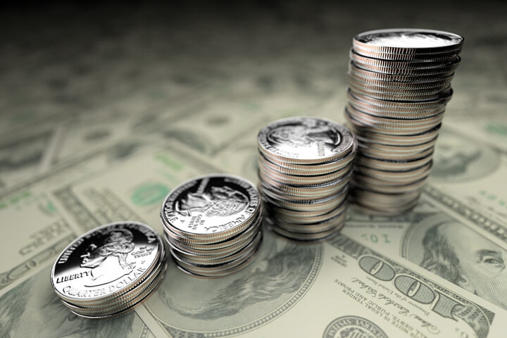 Increasing stacks of U.S. quarters on Benjamins with 24mm lens