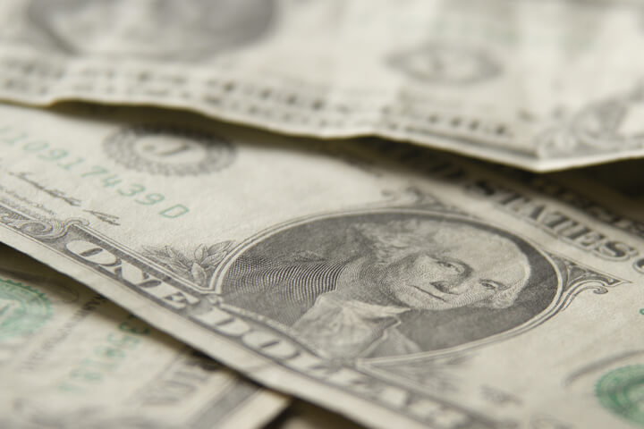 Random pile of wrinkled and crumpled dollar bills