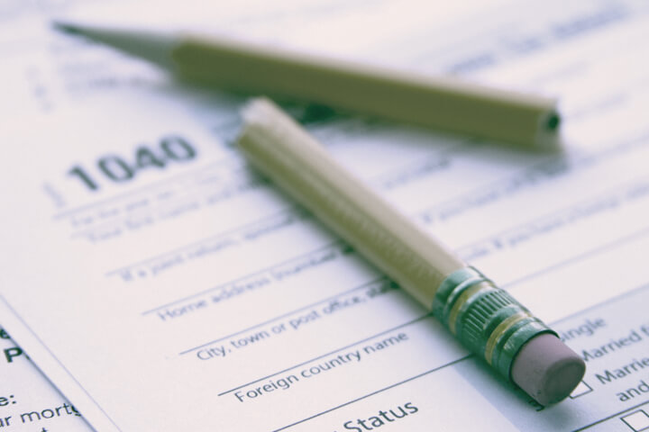 Broken pencil on tax form with vintage filter