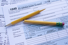Form 1040 and Schedule A with broken pencil illustrating tax frustration
