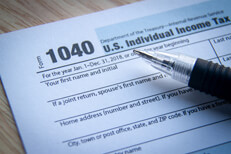 Ballpoint pen on IRS form 1040 with vignette