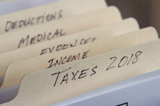 2018 tax folders Manila folders in filing cabinet showing 2018 taxes and tax category folders