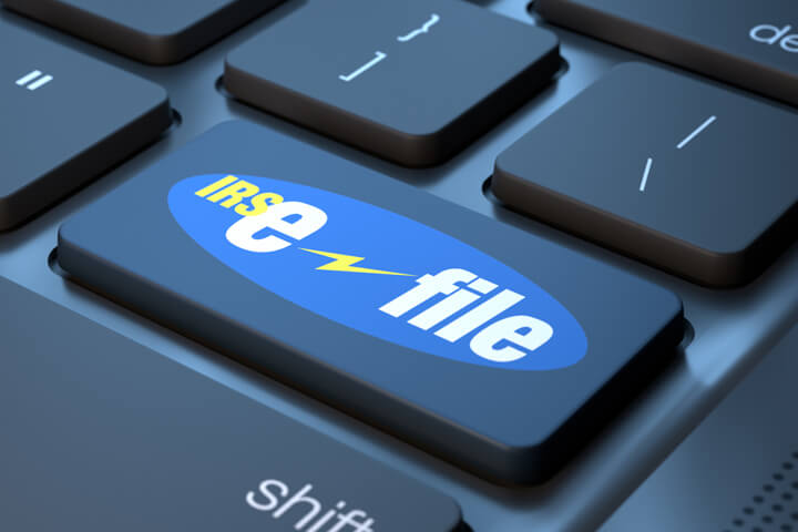 Laptop keyboard with IRS e-file key replacing enter key concept for filing taxes online