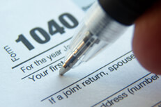 Close up photo of ballpoint pen signature on 1040 tax form