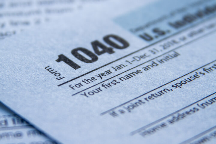 Close up photo of IRS form 1040 showing paper texture and depth of field blur