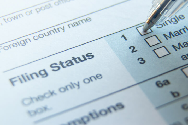 Photo of 1040 tax form filing status with ballpoint pen on Single option