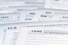 Overkill tax forms Photo of many tax forms concept demonstrating tax law complexity and need for simplification
