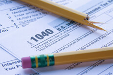 Tax time frustrations IRS 1040 form with broken pencil showing tax frustration, confusion, or overload