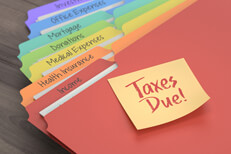 Manila folders taxes due Colorful manila tax category folders with Taxes Due sticky note