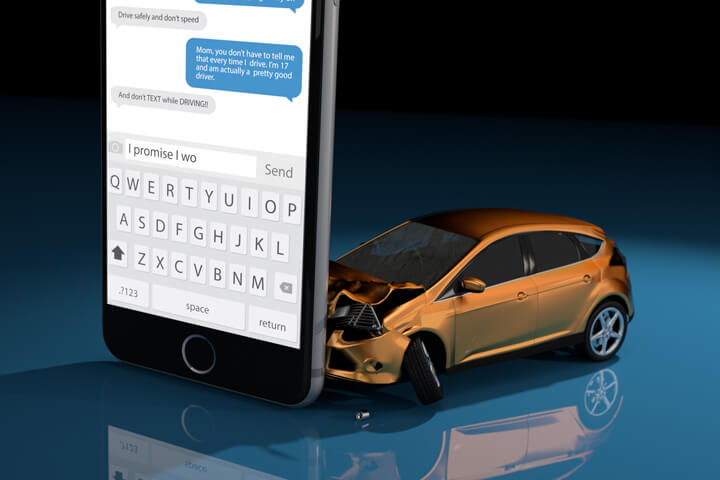 Orange compact car crashed into upright cell phone concept for texting while driving or distracted driving