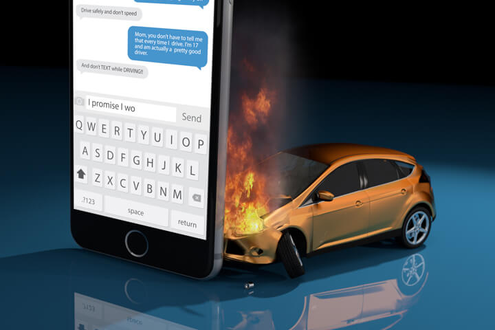 Image showing damage after texting while driving accident with car on fire