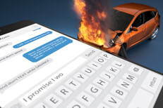 Concept image for texting while driving with car fire and large cell phone showing text message on screen