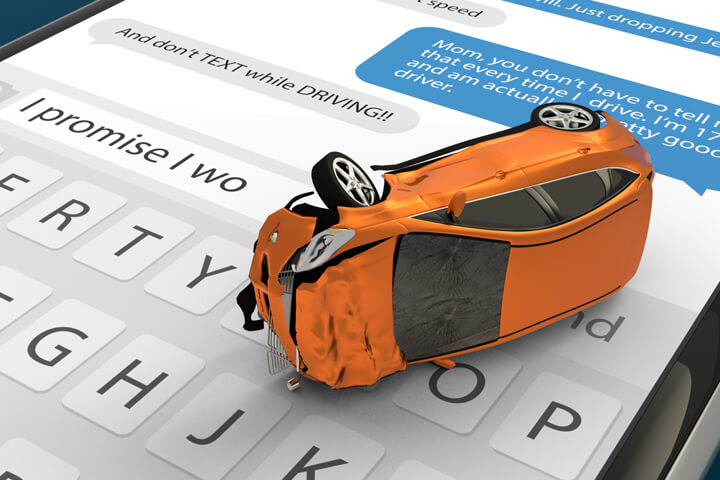 Car with extensive damage on top of cell phone showing text messages