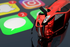 Driving while texting accident Rollover accident on top of shiny iPhone screen showing text message icon