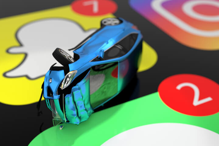 Small car damaged in rollover accident on top of cell phone screen showing Instagram, Snap Chat, Whats App, and iMessage app icons with message indicator