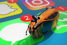 Small orange car with accident damage lying on close up cell phone screen showing Snap Chat, Instagram, iMessage, and Whats App icons